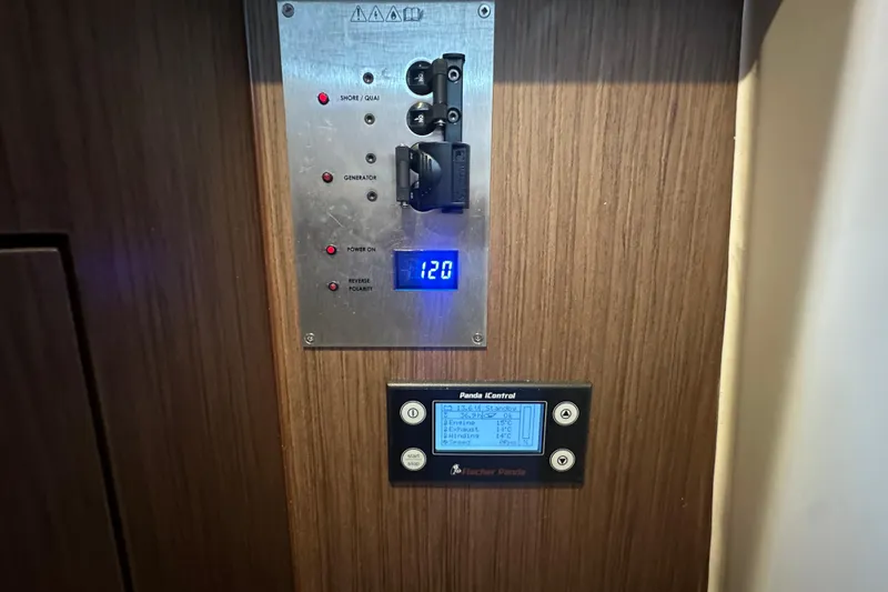 Slide: The Image of Control panel inside 2023 Beneteau Antares 11 Coupe, featuring electrical and generator controls. - 48