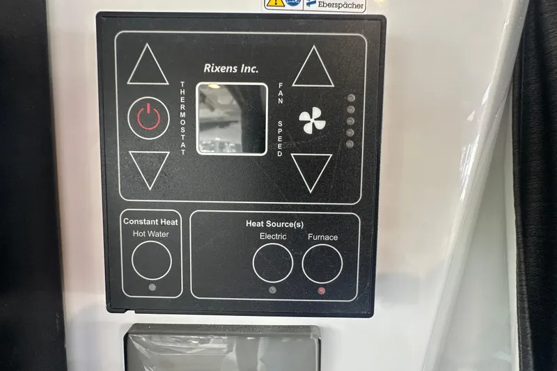 Slide: The Image of Control panel of 2023 Beneteau Antares 11 Coupe, featuring thermostat and fan speed settings. - 49