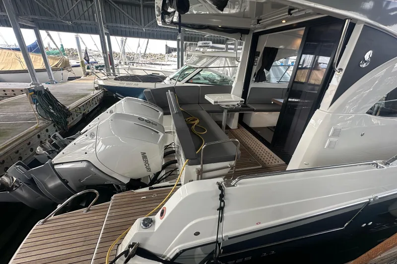 Slide: The Image of 2023 Beneteau Antares 11 Coupe with Mercury engines docked in a marina. - 5