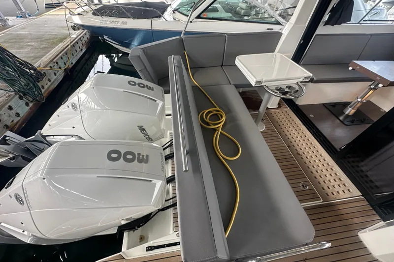 Slide: The Image of 2023 Beneteau Antares 11 Coupe with twin Mercury outboard engines, docked at marina. - 6