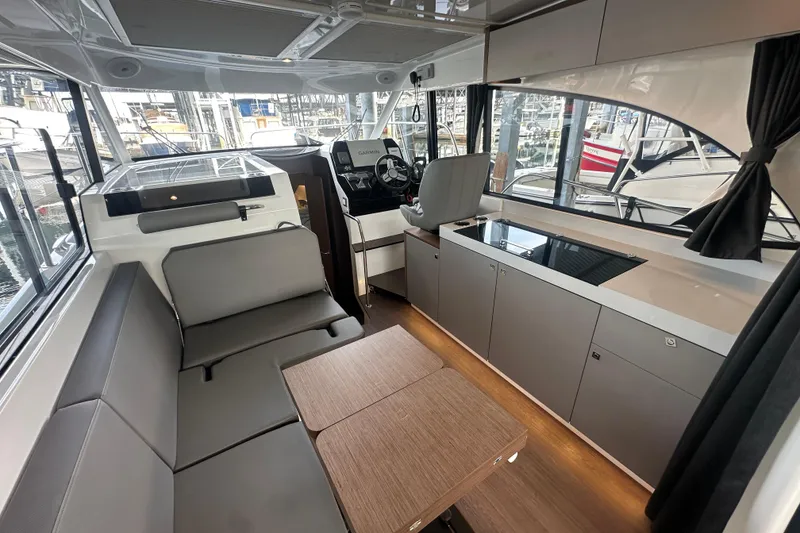 Slide: The Image of Interior of 2023 Beneteau Antares 11 Coupe, featuring modern seating and navigation area. - 9