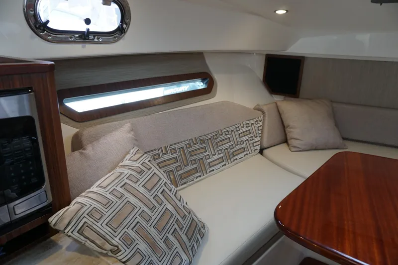 Slide: The Image of Interior of 2021 Pursuit OS 325 Offshore boat with cozy seating and cushions. - 17