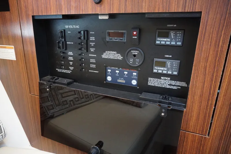 Slide: The Image of Control panel of a 2021 Pursuit OS 325 Offshore boat, featuring various switches and displays. - 22