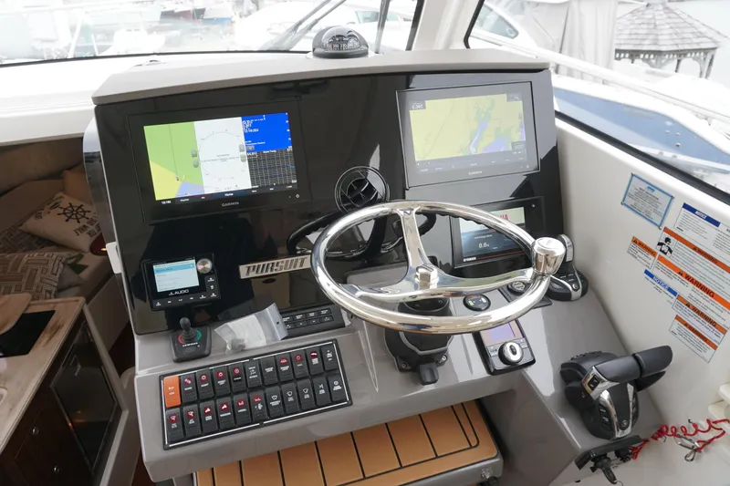 Slide: The Image of Helm of 2021 Pursuit OS 325 Offshore boat with navigation screens and controls. - 27