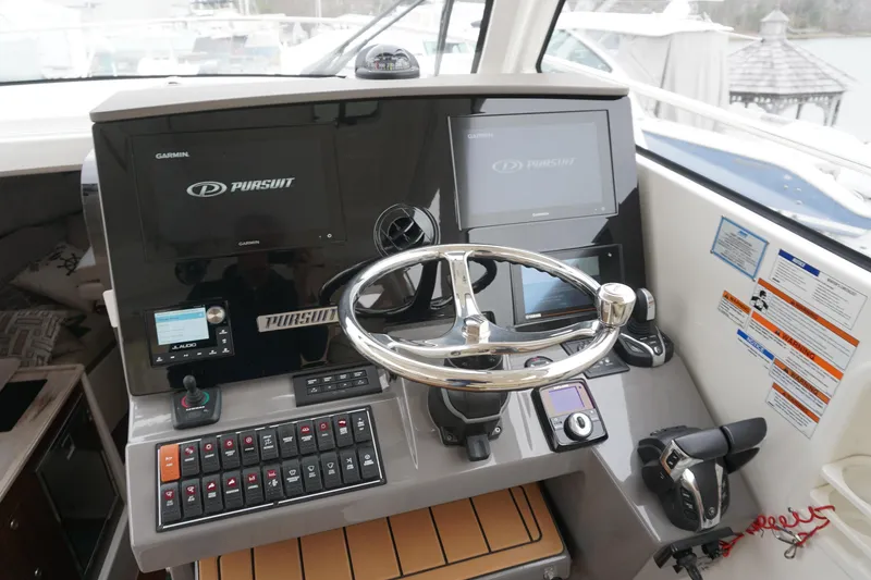 Slide: The Image of Helm of 2021 Pursuit OS 325 Offshore boat with modern controls and displays. - 28