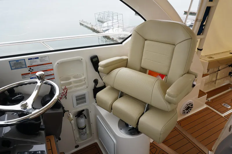 Slide: The Image of Captain's chair and helm of 2021 Pursuit OS 325 Offshore boat. - 31