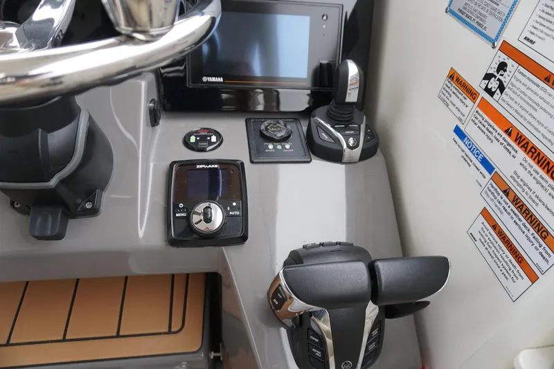 Slide: The Image of Control panel of 2021 Pursuit OS 325 Offshore boat with Yamaha controls and warning labels. - 33