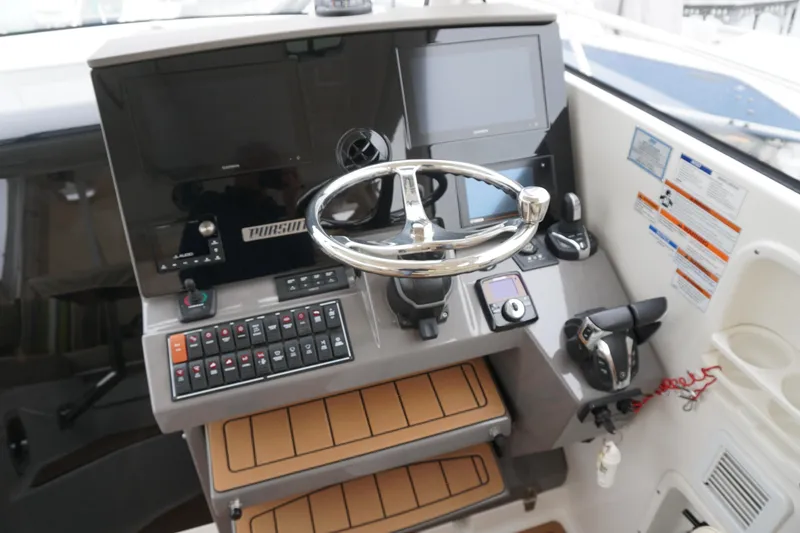 Slide: The Image of Helm of 2021 Pursuit OS 325 Offshore boat with modern controls and steering wheel. - 34