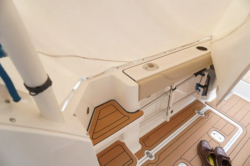 Slide: The Image of 2021 Pursuit OS 325 Offshore boat interior with teak flooring and storage compartments. - 36