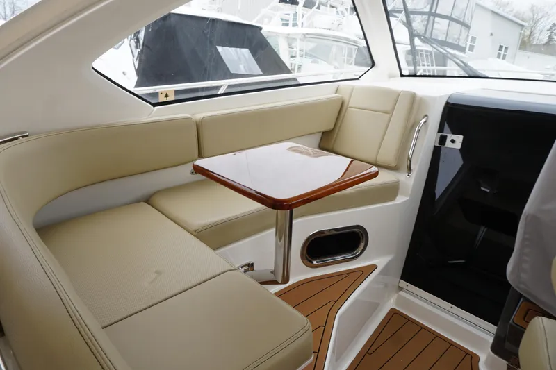 Slide: The Image of Interior of 2021 Pursuit OS 325 Offshore boat with beige seating and wooden table. - 37