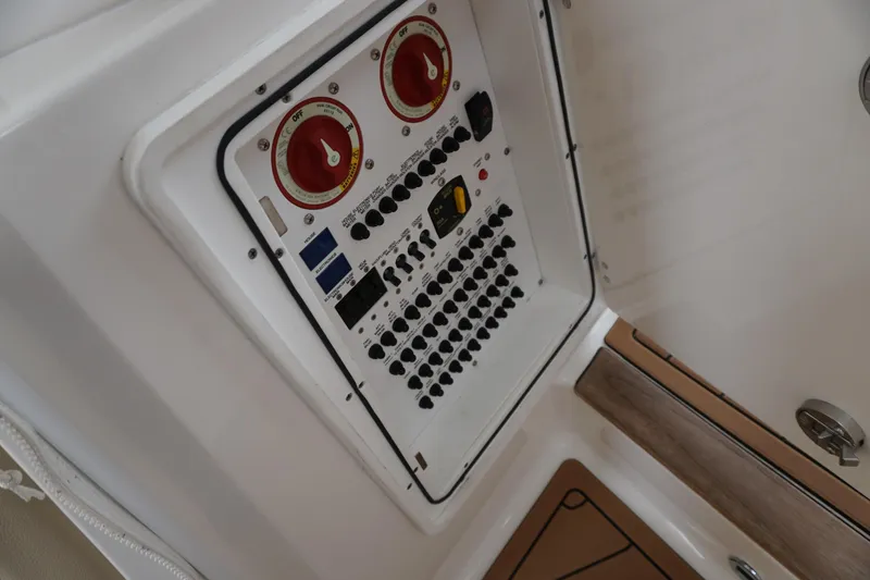 Slide: The Image of Electrical panel of 2021 Pursuit OS 325 Offshore boat, featuring switches and controls. - 39