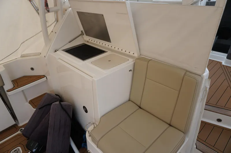 Slide: The Image of 2021 Pursuit OS 325 Offshore boat interior with seating and storage area. - 41