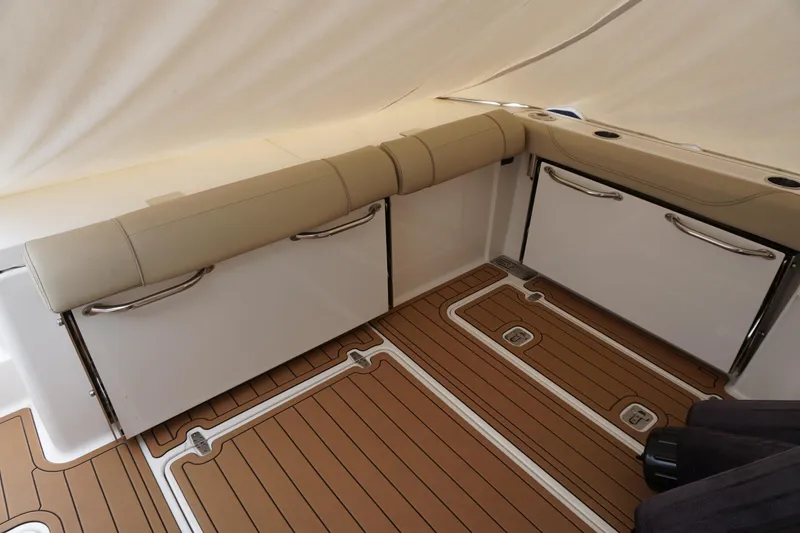 Slide: The Image of 2021 Pursuit OS 325 Offshore boat interior with cushioned seating and teak flooring. - 42
