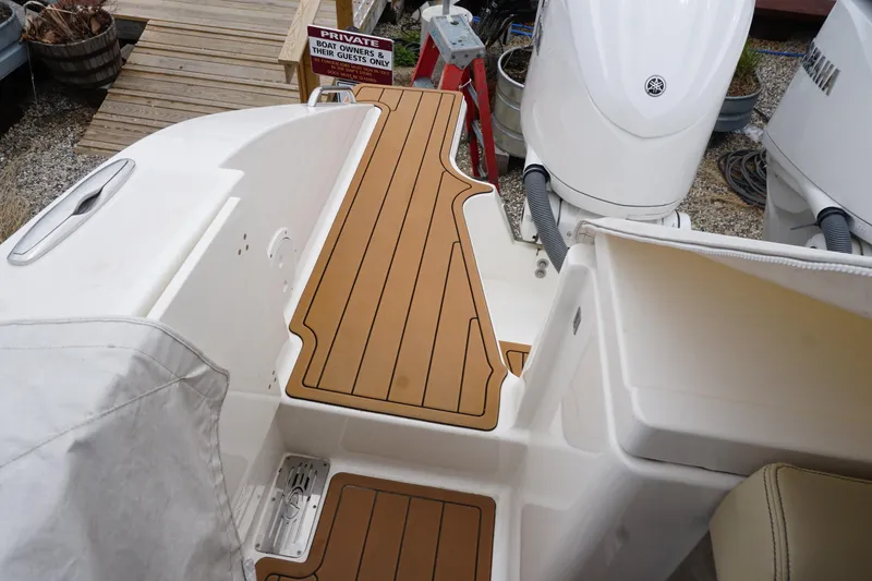 Slide: The Image of 2021 Pursuit OS 325 Offshore boat deck with teak flooring and Yamaha outboard engines. - 43