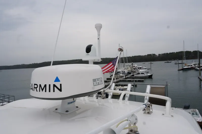 Slide: The Image of 2021 Pursuit OS 325 Offshore boat with Garmin radar at marina. - 8