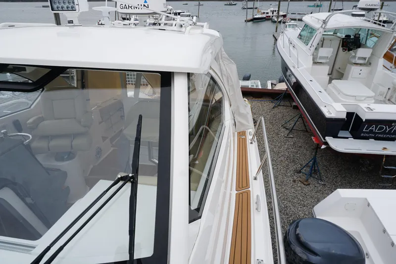 Slide: The Image of 2021 Pursuit OS 325 Offshore boat docked, showcasing sleek design and modern features. - 9