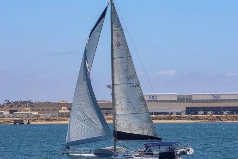 The Image of Sailboat Catalina 42 MkII 2000 sailing near industrial buildings on a sunny day. - 0