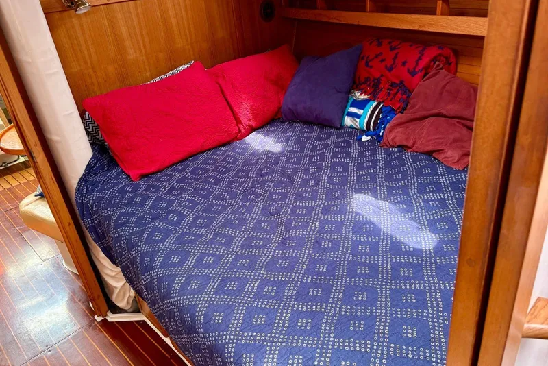 Slide: The Image of Cozy cabin bed with colorful pillows in a 2000 Catalina 42 MkII sailboat. - 13