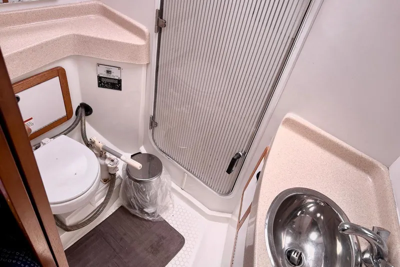 Slide: The Image of Bathroom of 2000 Catalina 42 MkII yacht with toilet, sink, and shower area. - 14