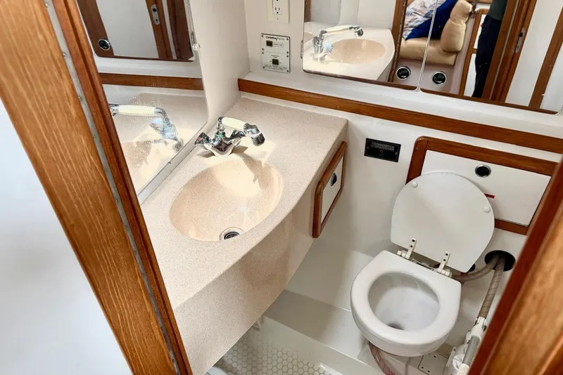 Slide: The Image of Bathroom interior of a 2000 Catalina 42 MkII yacht, featuring sink and toilet. - 18