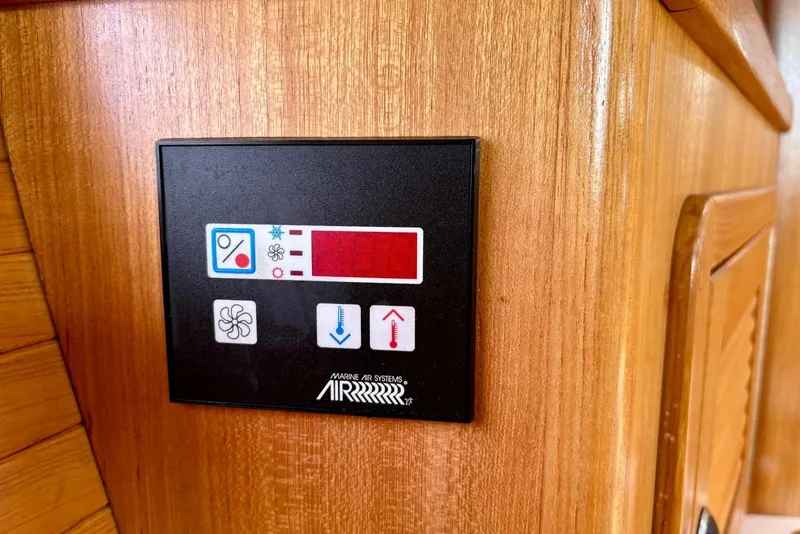 Slide: The Image of Control panel on a 2000 Catalina 42 MkII yacht, featuring temperature and fan settings. - 21