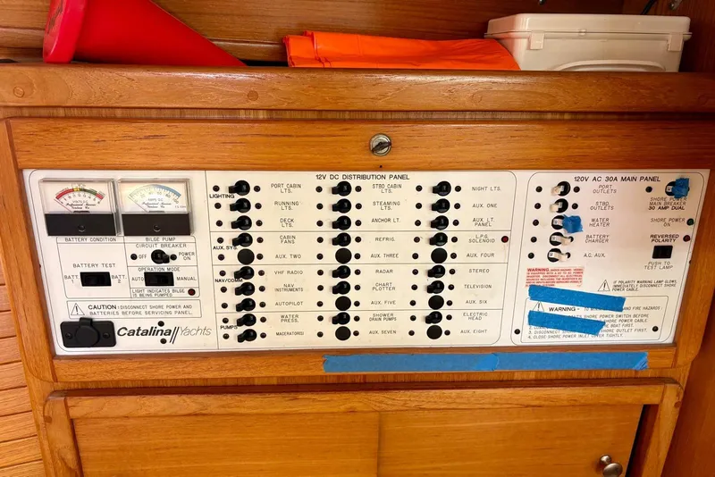 Slide: The Image of Electrical control panel on a 2000 Catalina 42 MkII yacht, featuring various switches and gauges. - 22