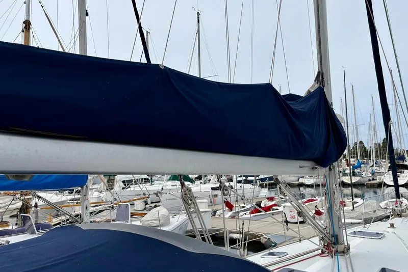 Slide: The Image of Catalina 42 MkII sailboat from 2000 docked in a marina, featuring a covered boom. - 25