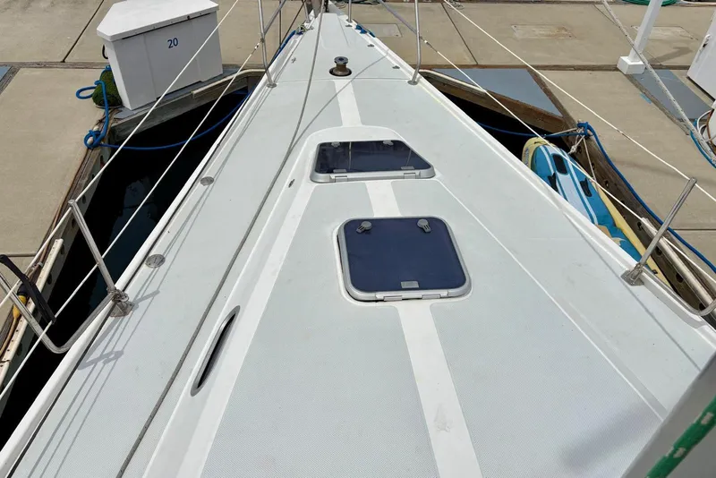 Slide: The Image of Deck view of a 2000 Catalina 42 MkII sailboat docked at a marina. - 26