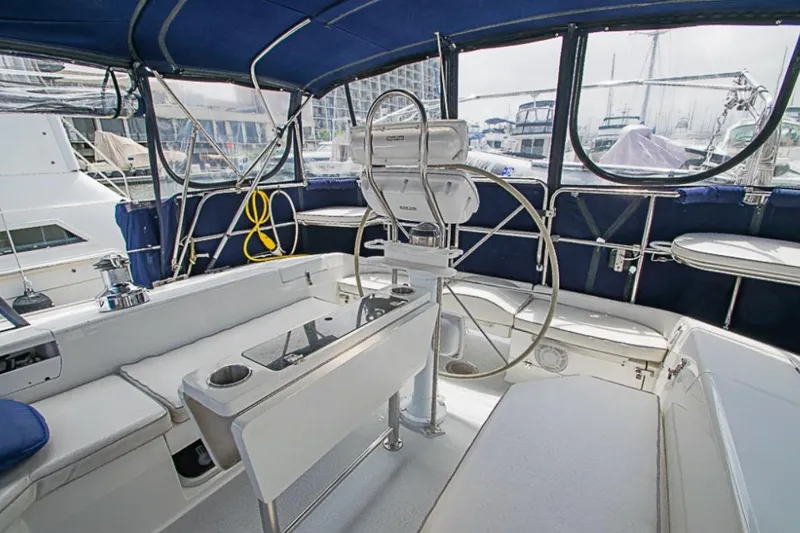 Slide: The Image of Cockpit of 2000 Catalina 42 MkII sailboat with blue canopy and steering wheel. - 3