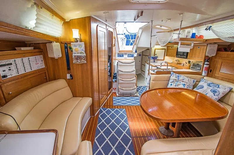 Slide: The Image of Interior of a 2000 Catalina 42 MkII sailboat with cozy seating and wooden finishes. - 5