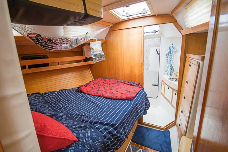 Slide: The Image of Cozy cabin interior of a 2000 Catalina 42 MkII sailboat with bed and bathroom. - 6