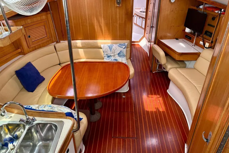 Slide: The Image of Interior of 2000 Catalina 42 MkII sailboat with wood finish and cozy seating area. - 8