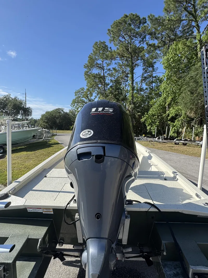 Slide: The Image of 2016 Xpress XP20CC boat with outboard motor, parked outdoors. - 15