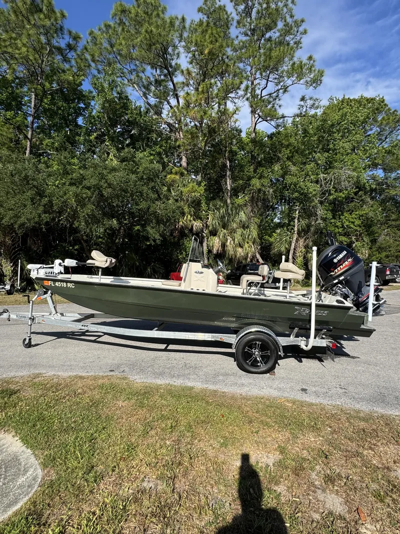 Slide: The Image of 2016 Xpress XP20CC boat parked on trailer outdoors. - 19