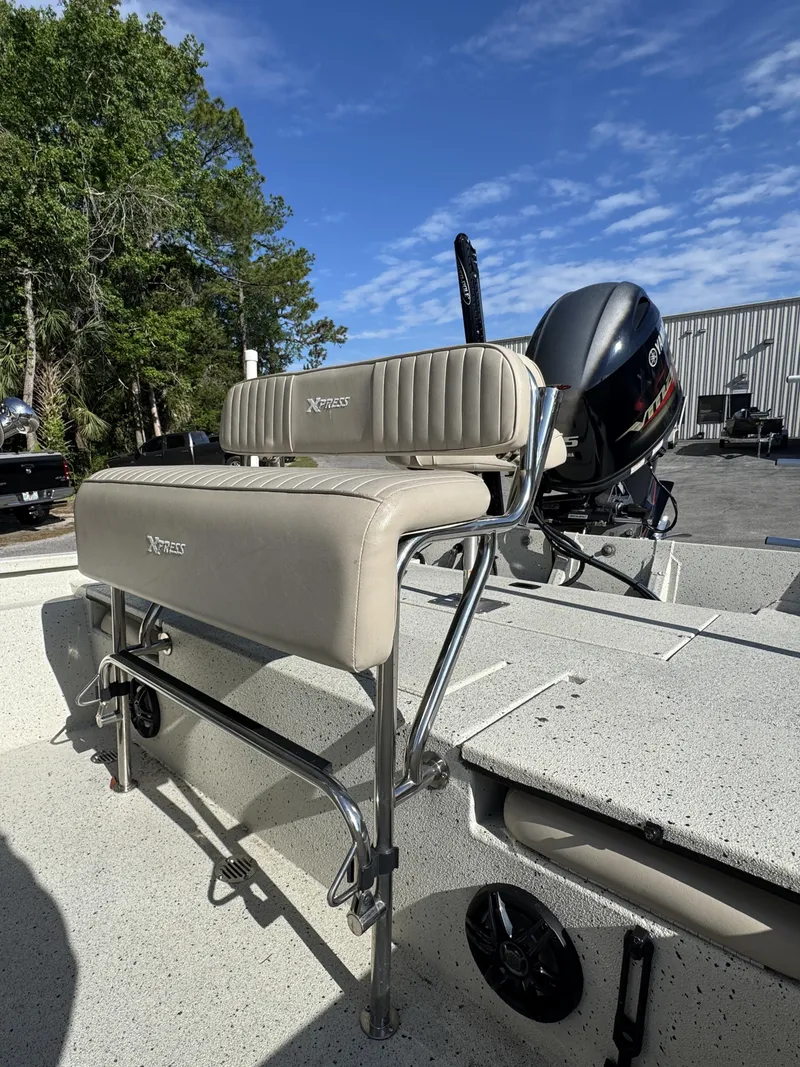 Slide: The Image of 2016 Xpress XP20CC boat with cushioned seat and outboard motor. - 22