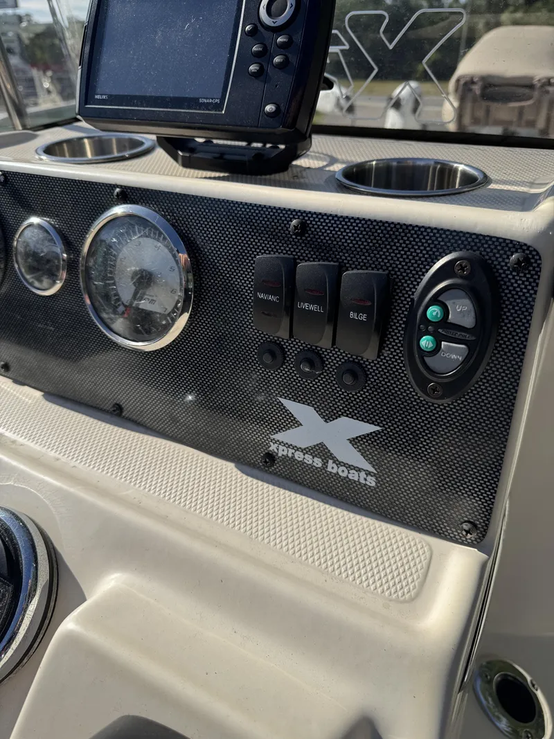 Slide: The Image of Dashboard of a 2016 Xpress XP20CC boat with controls and display. - 28
