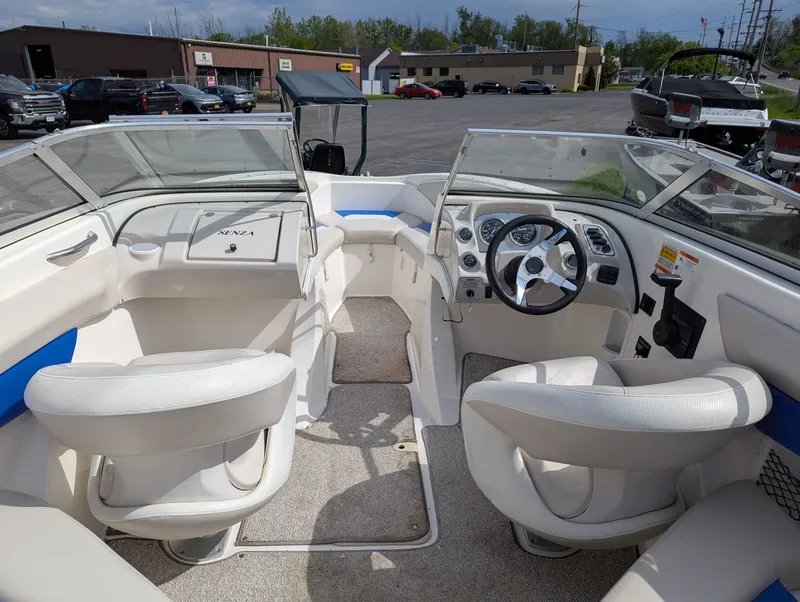 Slide: The Image of Interior of a 2006 Larson Senza 206 boat with steering console. - 3