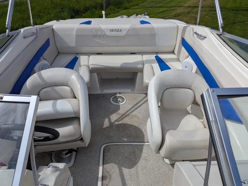 Slide: The Image of Interior of a 2006 Larson Senza 206 boat with white seating. - 8