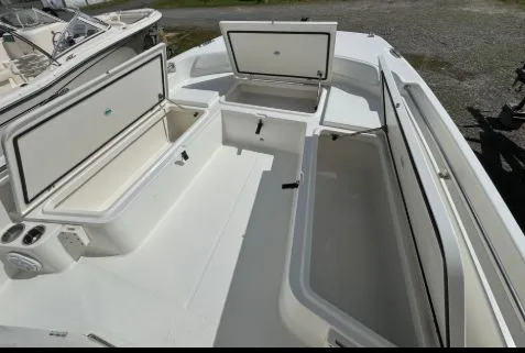 Slide: The Image of 2022 World Cat 235 CC boat with open storage compartments. - 6