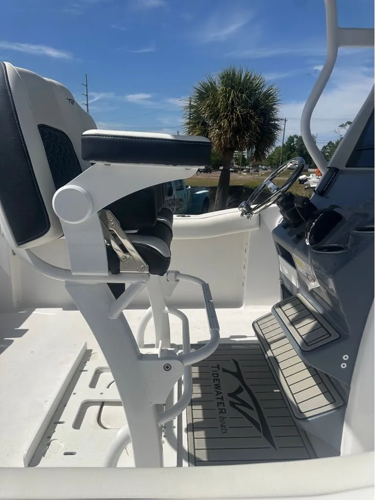 Slide: The Image of 2025 Tidewater 232 CC Adventure boat helm in sunny weather. - 5