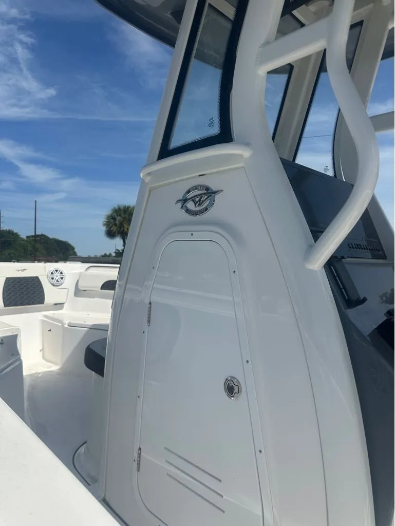 Slide: The Image of 2025 Tidewater 232 CC Adventure boat, side view with cabin door. - 7