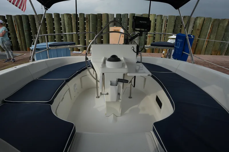 Slide: The Image of 1997 Hunter 336 sailboat cockpit with blue cushions and steering wheel. - 10