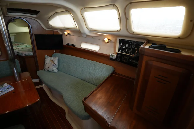 Slide: The Image of Interior of a 1997 Hunter 336 sailboat with seating, navigation equipment, and wooden finishes. - 12