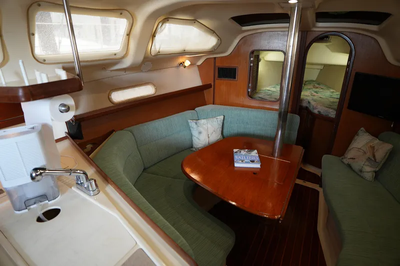 Slide: The Image of Cozy interior of 1997 Hunter 336 sailboat with dining area and kitchenette. - 13