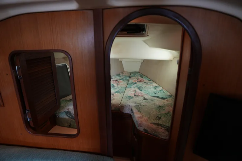 Slide: The Image of Cozy cabin interior of 1997 Hunter 336 sailboat with floral bedding. - 14