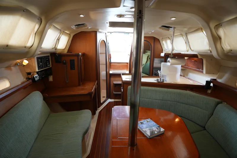 Slide: The Image of Interior of a 1997 Hunter 336 sailboat with cozy seating and wooden finishes. - 15