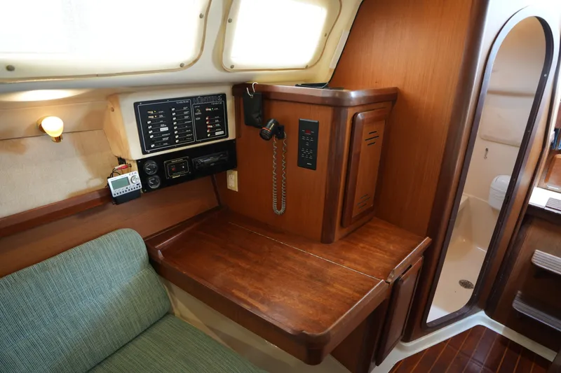Slide: The Image of Interior of a 1997 Hunter 336 sailboat with navigation equipment and wooden cabinetry. - 16