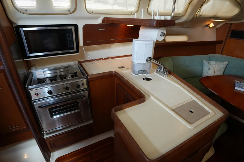 Slide: The Image of Interior of 1997 Hunter 336 yacht kitchen with stove, microwave, and sink. - 17