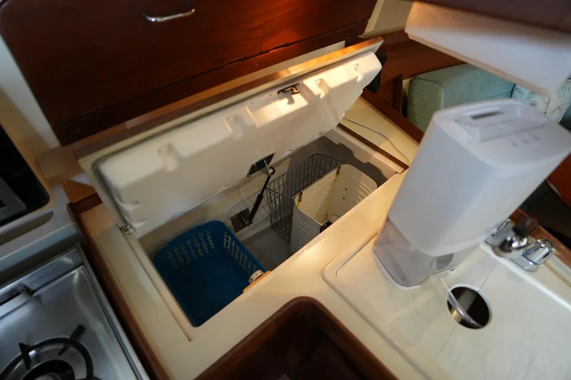 Slide: The Image of Interior of a 1997 Hunter 336 sailboat galley with open storage compartment. - 18