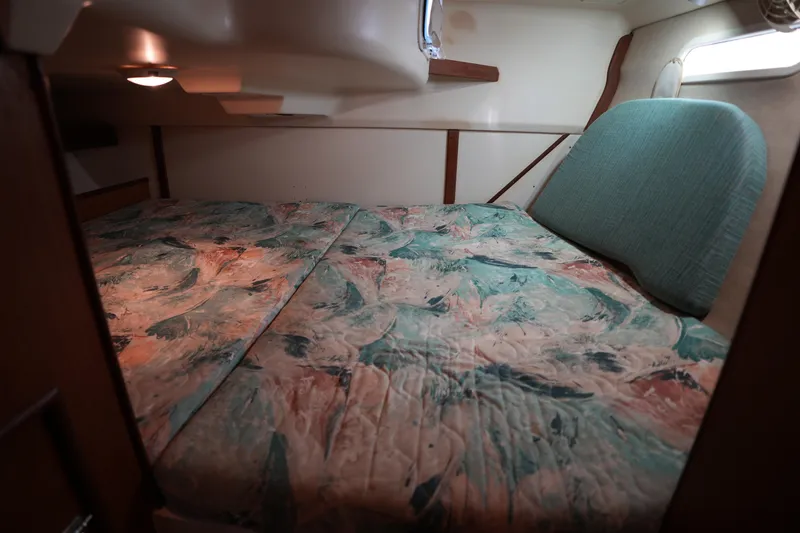 Slide: The Image of Cozy cabin interior of a 1997 Hunter 336 sailboat with patterned bedding. - 22